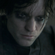 Robert Pattinson as Batman in The Batman, in costume and sans mask.